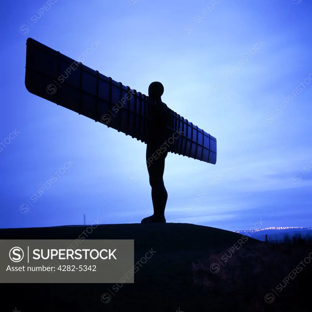 England, Tyne and Wear, Gateshead. Angel of the North at dusk. The statue's wings measure 54 metres making it wider than the Statue of Liberty is tall.