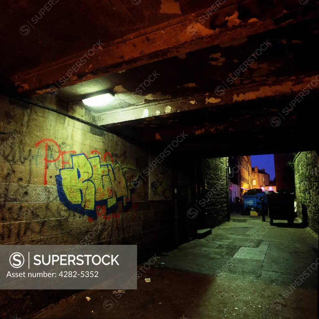 Scotland, Edinburgh, Edinburgh. Tunnel with graffiti at night. The word 'graffiti' is the plural of 'graffito' and originates from the Italian word 'graffiato' which means scratched.