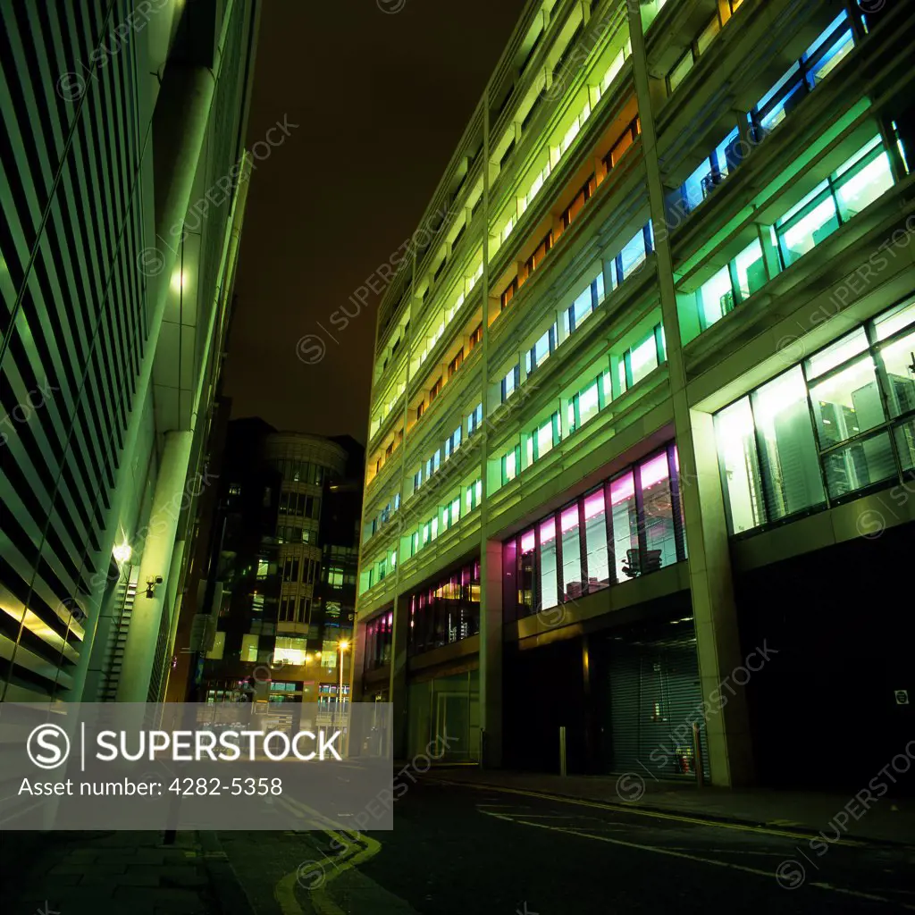 England, London, Moorgate. Coloured building in Moorgate at night. Moorgate was one of the minor gates of the old London Wall.