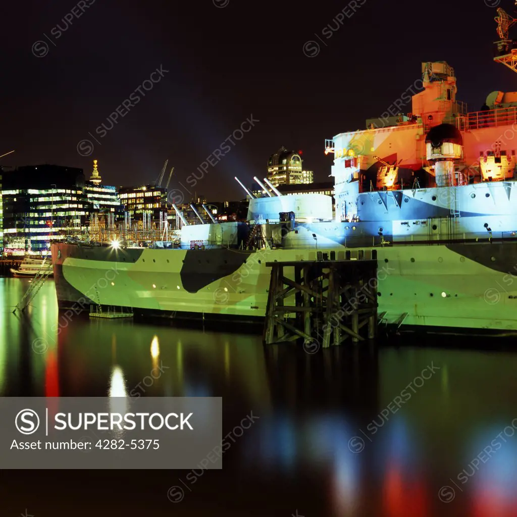 England, London, South Bank. HMS Belfast on the River Thames at night.