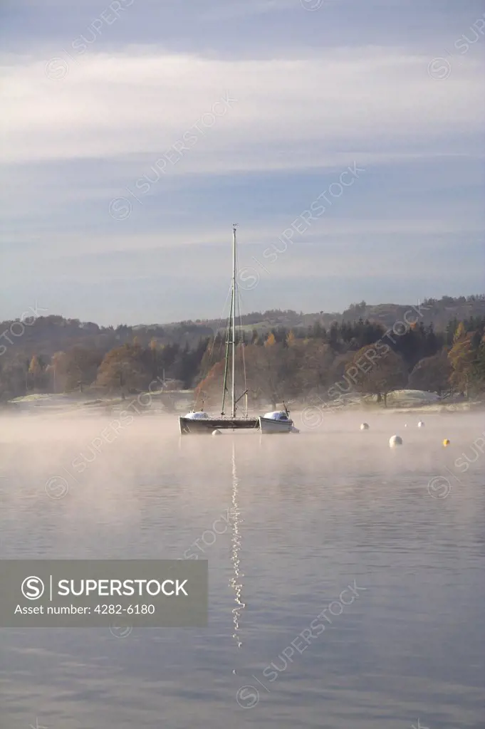 England, Cumbria, Lake Windemere. A lone catamaran on Lake Windemere.