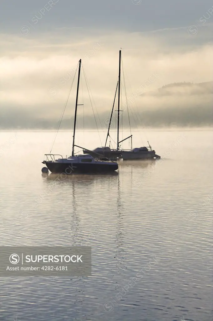 England, Cumbria, Lake Windemere. Sailing boats moored on Lake Windermere.