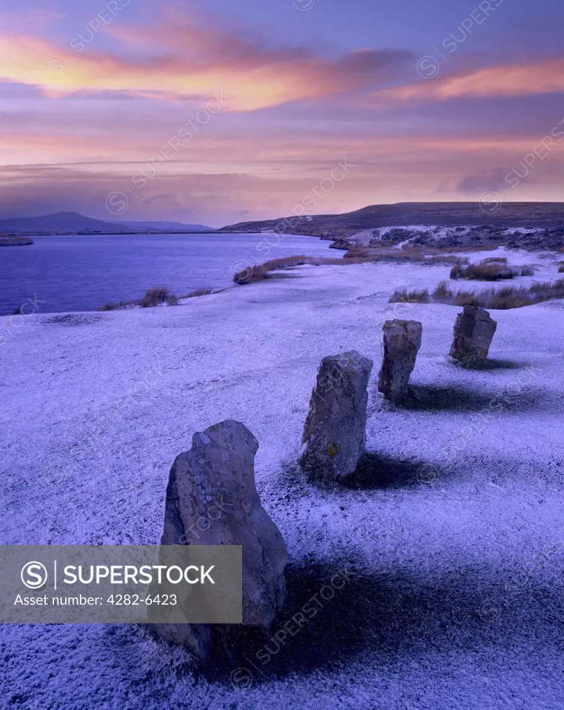 Wales, Monmouthshire, Abergavenny. Lake and standing stones on a snow covered mountain top.