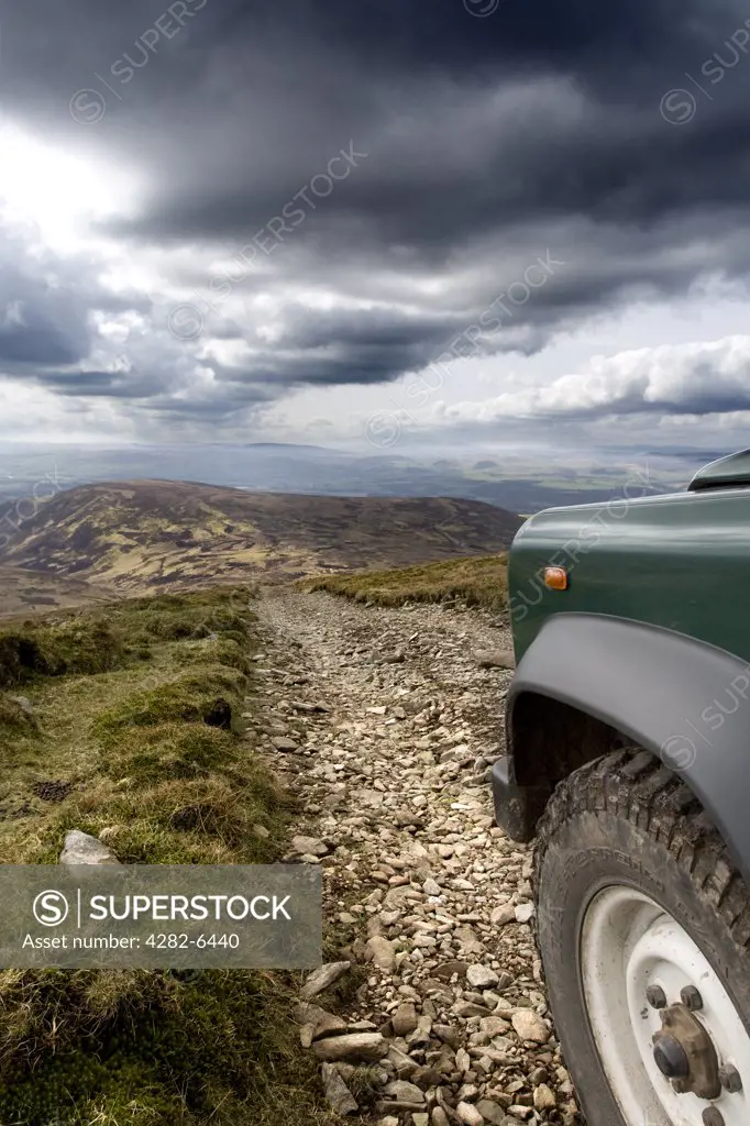 Scotland, Dumfries and Galloway, Drumlanrig. A Land Rover on a rough track in Drumlanrig Country Estate.