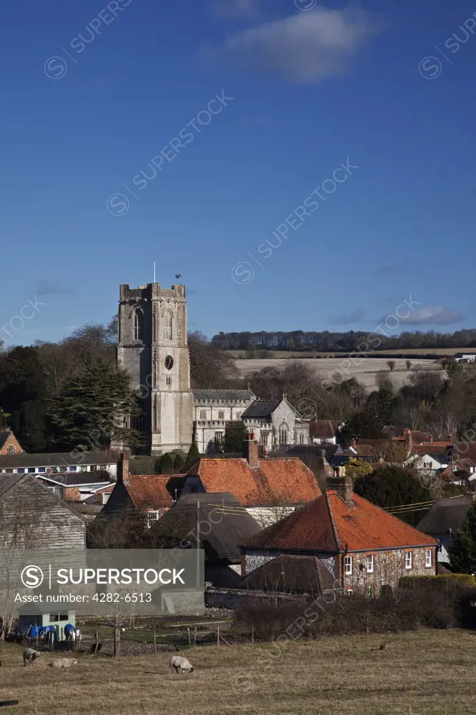 England, Wiltshire, Aldbourne. View across farmland to the parish church of St Michaels and the village of Aldbourne.