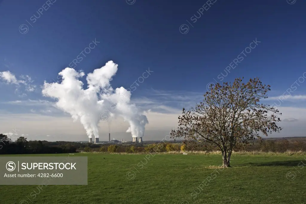England, Oxfordshire, Didcot. White smoke billowing from the cooling towers of Didcot Power Station into a clear blue sky.