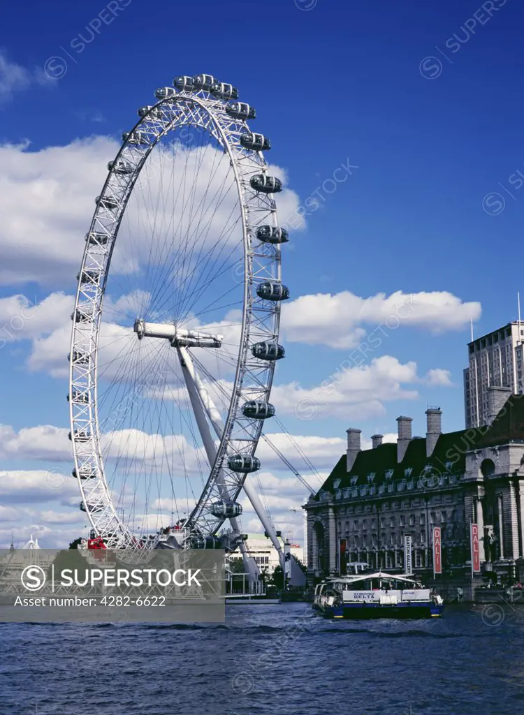 England, London, South Bank. The London Eye and County Hall from the River Thames.