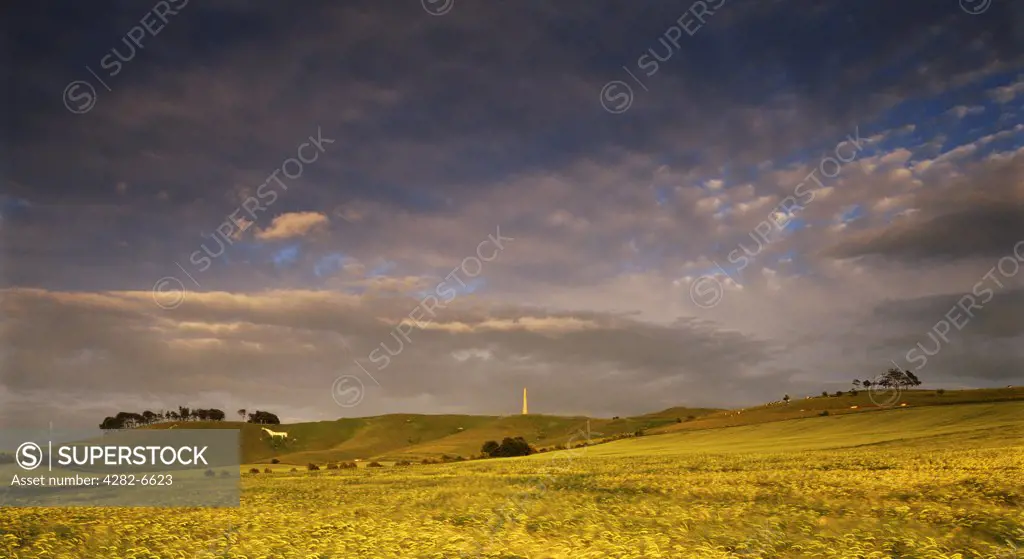 Enngland, Wiltshire, Cherhill. Cherhill Monument and White Horse in storm light. The monument stands 125 feet above the hill. It is said that this is the highest point between London and Bristol.