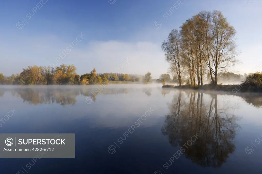 England, Wiltshire, Lower Moor Farm nature reserve. A misty autumnal dawn at Mallard Lake at the Wiltshire Wildlife Trust's new Lower Moor Farm nature reserve.