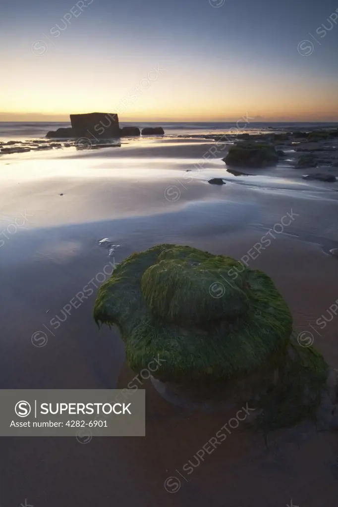 England, Essex, Walton-on-the-Naze. A pillbox on the beach at the Naze in early dawn light.