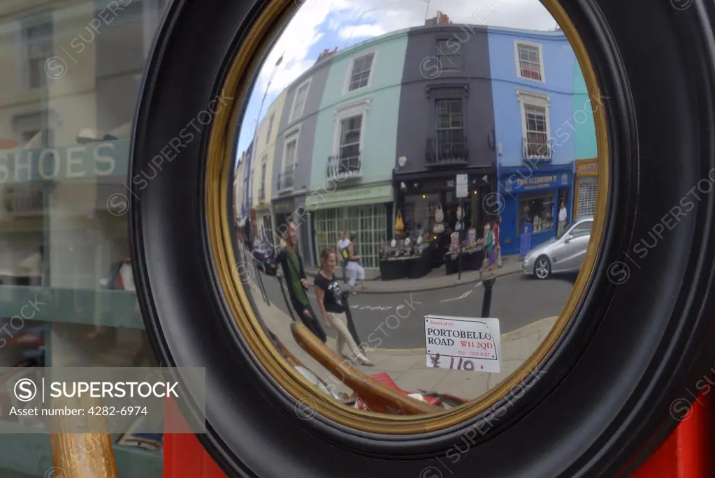 England, London, Notting Hill. Antique mirror in Portobello road with out-of-focus reflection of shoppers.