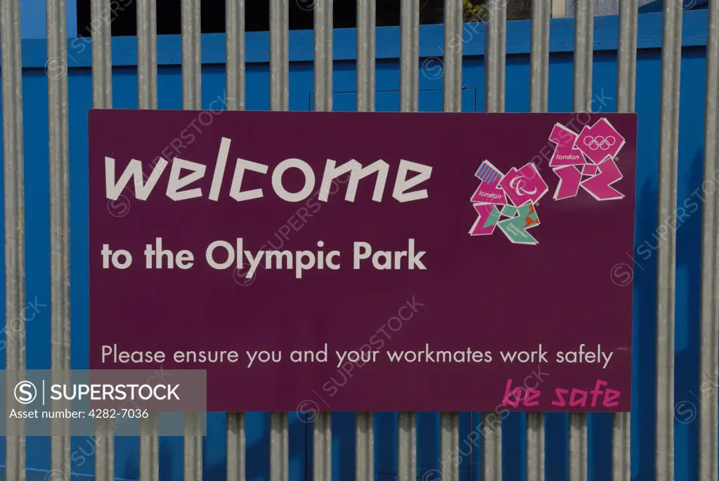 England, London, Stratford. A Welcome notice on a gate at the entrance to the Olympic Park construction site featuring the logos for the London Olympics and Paralympics 2012.