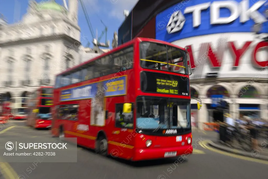 England, London, Piccadilly Circus. London buses passing the large iconic advertising signs in Piccadilly Circus.