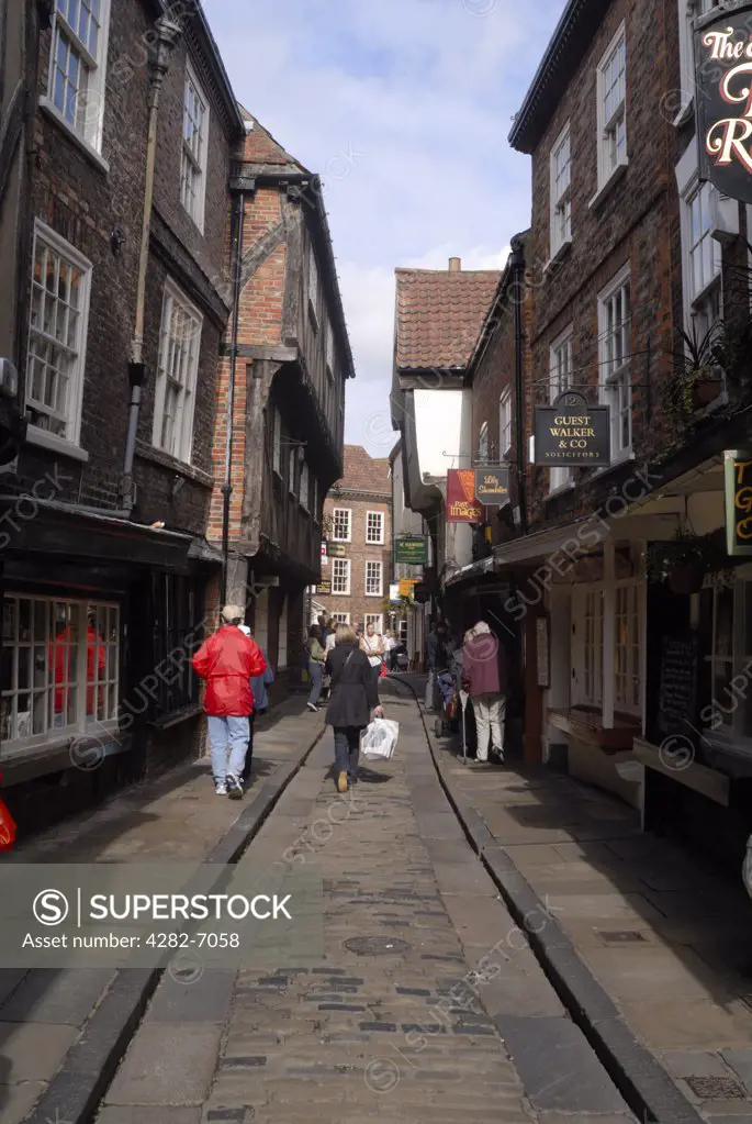 England, North Yorkshire, York. People walking along the Shambles in York.