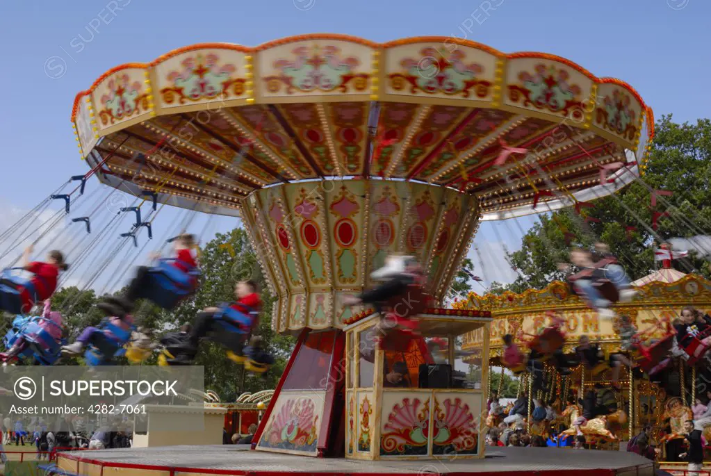 England, Kent, Detling. A traditional swing chair ride in motion at the Kent County Show.