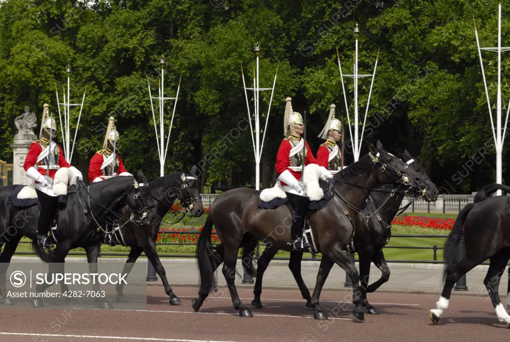 England, London, Buckingham Palace. Horse Guards riding along the Mall near Buckingham Palace.