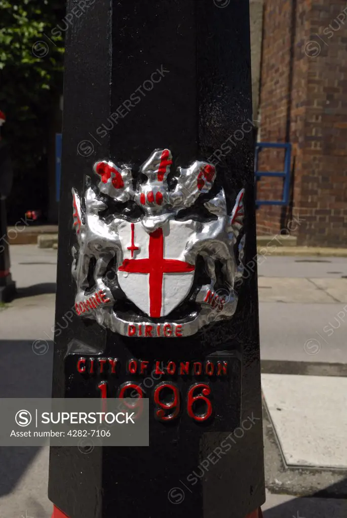 England, London, City of London. A close-up of a bollard bearing a crest in the City of London.