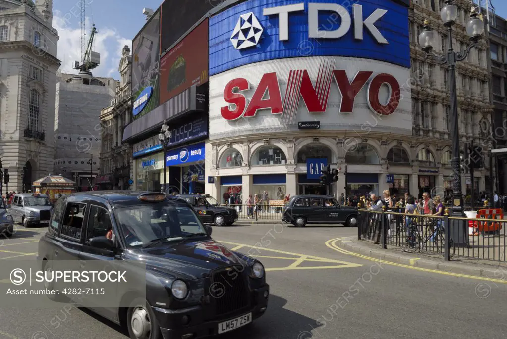 England, London, Piccadilly Circus. London taxis driving past the famous large advertisements in Piccadilly Circus.