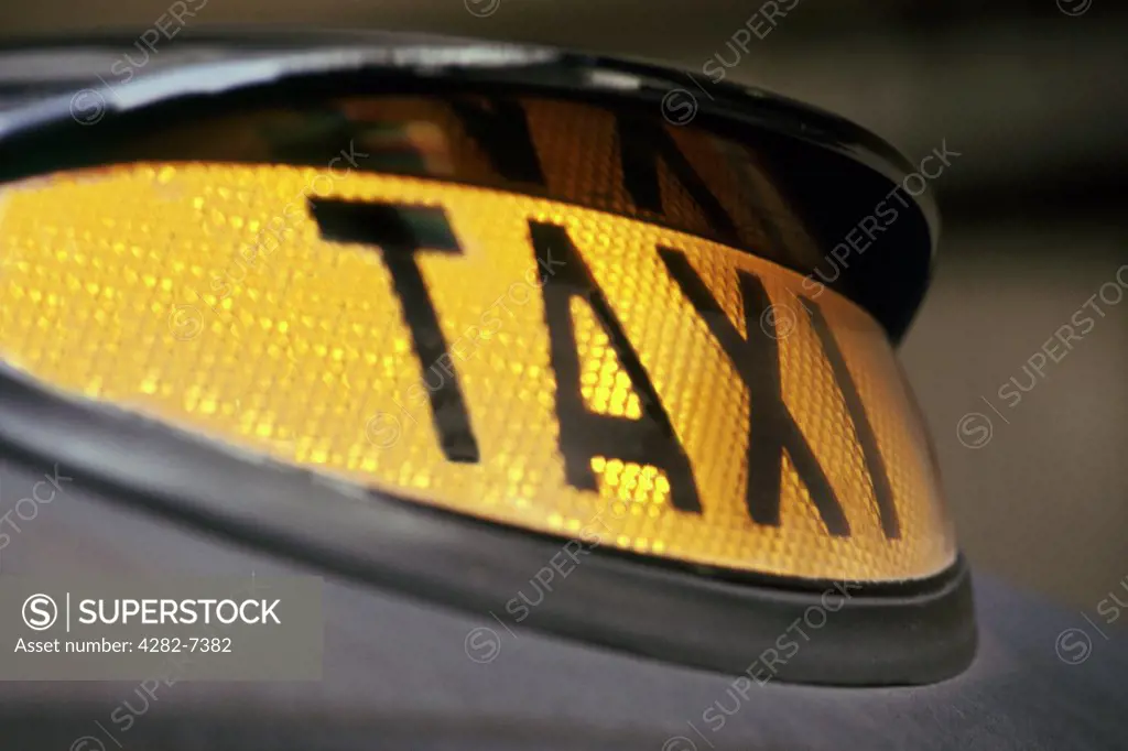 England, London, London. Taxi sign on top of a black cab.