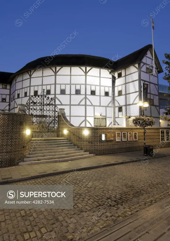 England, London, South Bank. Dusk view of Shakespeare's Globe Theatre on the banks of the River Thames.