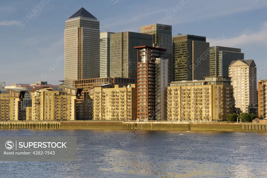 England, London, Canary Wharf. Evening view across the River Thames showing the commercial buildings of Canary Wharf and residential apartments of Ocean Wharf on the Isle of Dogs.