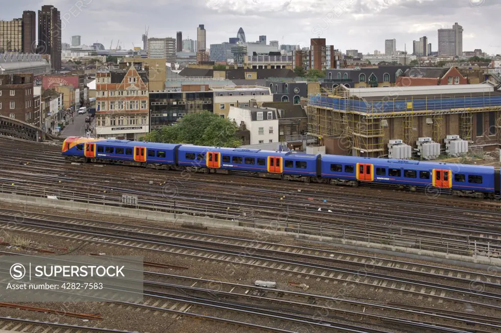 England, London, Waterloo. View of a train and rail tracks outside Waterloo train station.