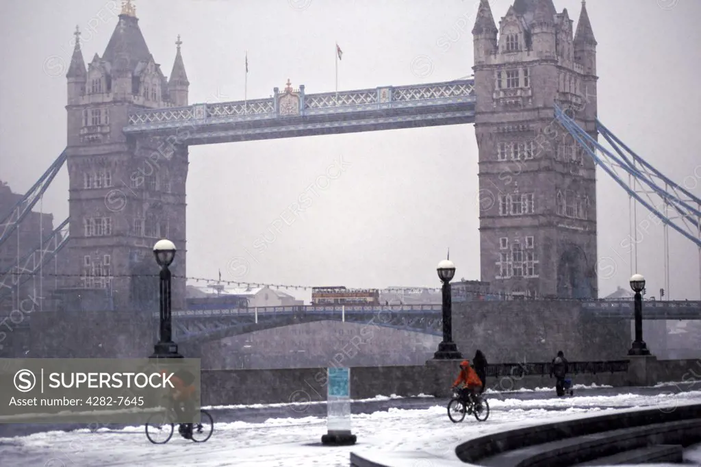 England, London, Tower Bridge. A view to Tower Bridge from the bank of the River Thames after a snowfall.