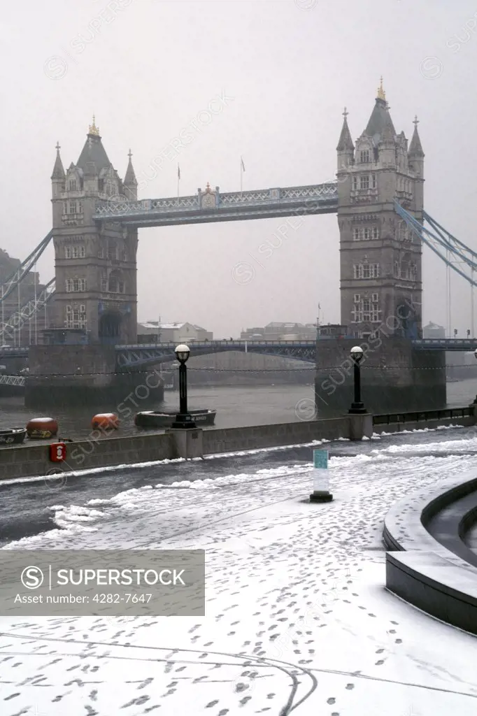 England, London, Tower Bridge. A view to Tower Bridge from the bank of the River Thames after a snowfall.