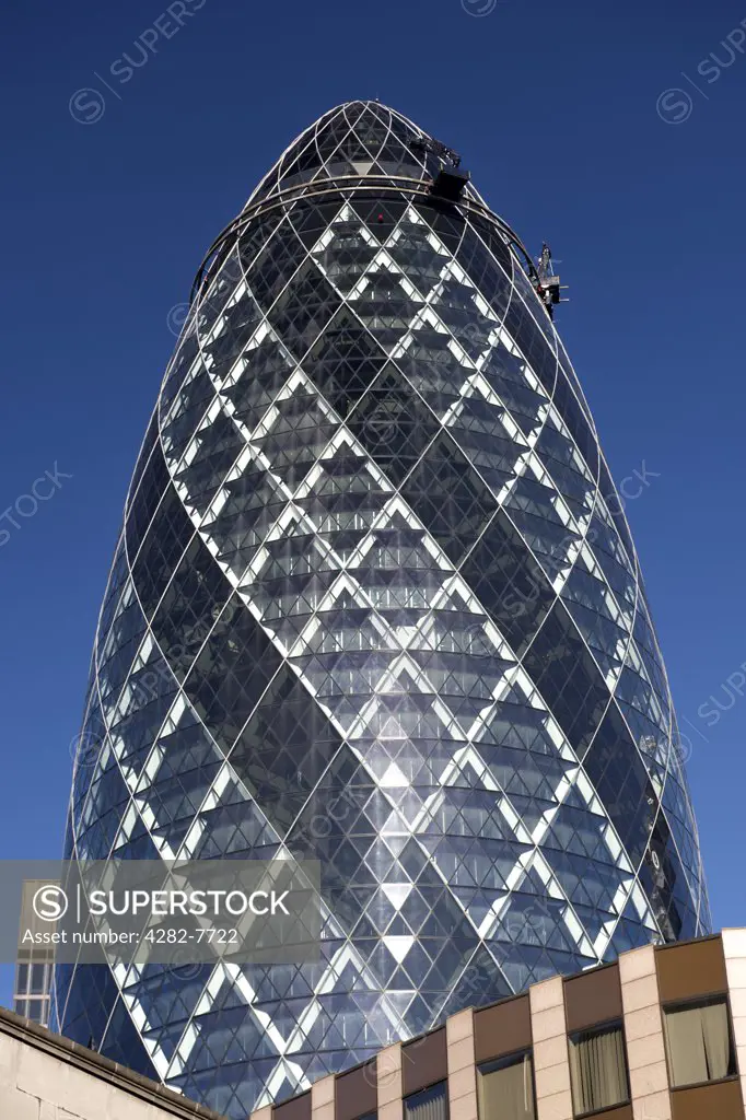 England, London, The City of London. 30 St Mary Axe, (also known as the Gherkin and the Swiss Re Building) designed by Norman Foster. At 180 metres high it is the sixth tallest building in London.