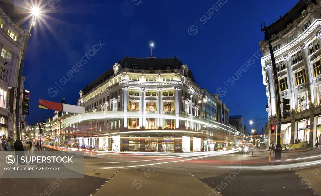 England, London, Oxford Circus. Light trails from traffic passing through Oxford Circus at night.