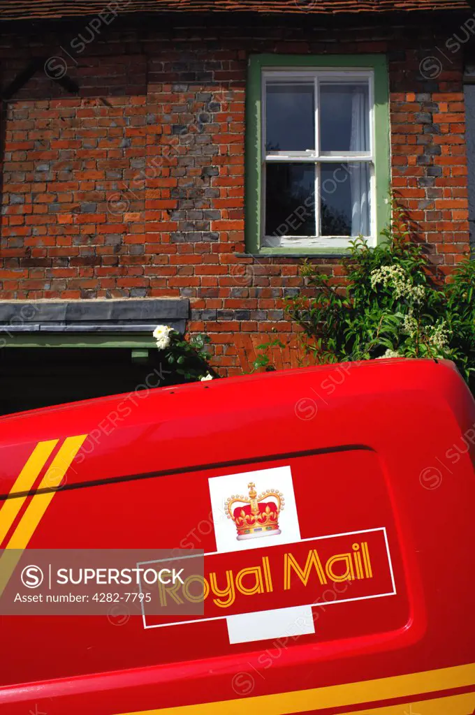 England, Buckinghamshire, West Wycombe. Mail van outside traditional West Wycombe cottage. West Wycombe village is owned by the National Trust.