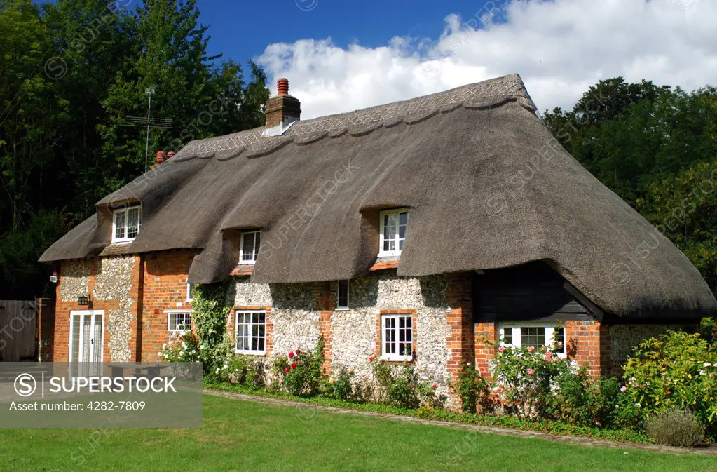 England, Buckinghamshire, West Wycombe. Traditional English thatched cottage in West Wycombe. West Wycombe village is owned by the National Trust.