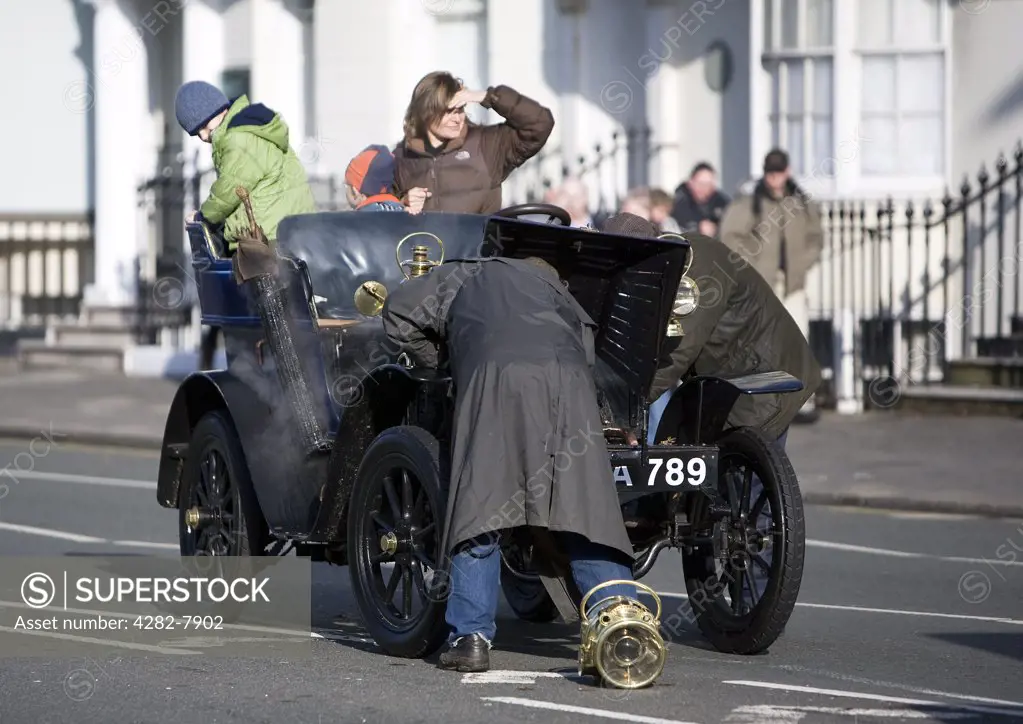 England, City of Brighton and Hove, Brighton. Participants try to fix an overheated engine during the 2008 London to Brighton Veteran Car Run.