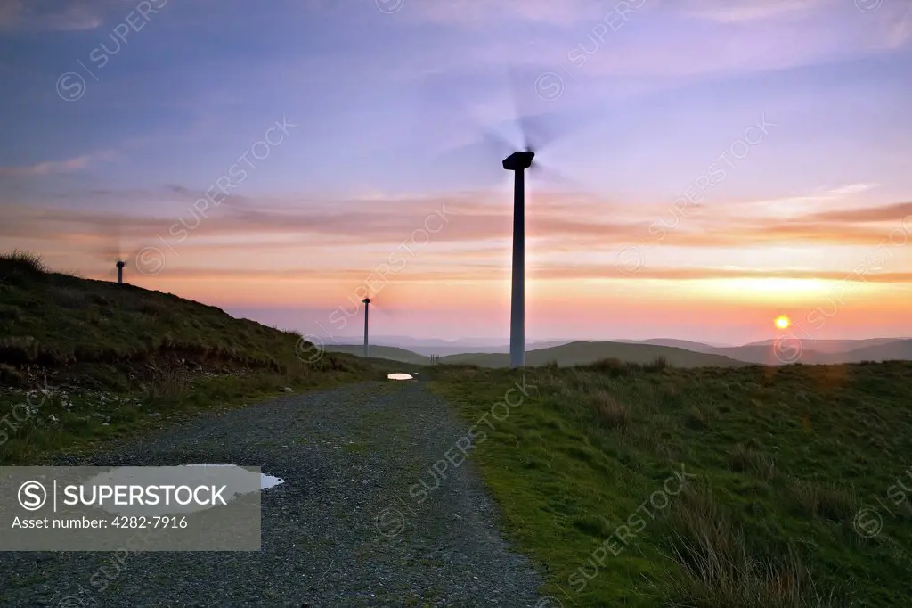 Wales, Ceredigion, Llwernog. Sunset over Rheidol wind farm located near Aberystwyth in Wales.