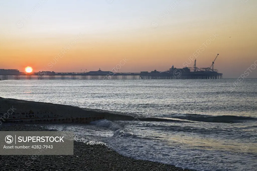 England, City of Brighton and Hove, Brighton. Sunrise over Brighton's Pavillion Pier.