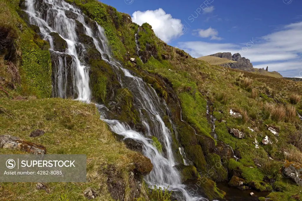 Scotland, Highland, The Storr. The Bride's Veil waterfall with the Old Man of Storr in the distance on the Isle of Skye.