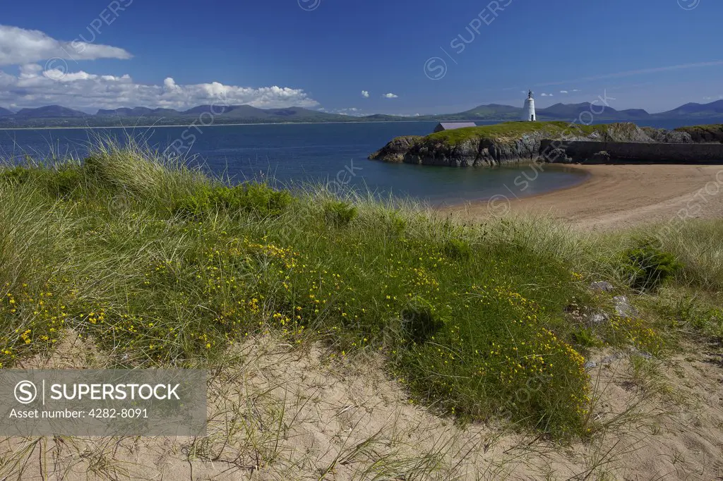 Wales, Anglesey, Llanddwyn Island. A view across the Menai Strait from Twr Bach (Little Tower) lighthouse on Llanddwyn Island with the mountains of Snowdonia in the distance.