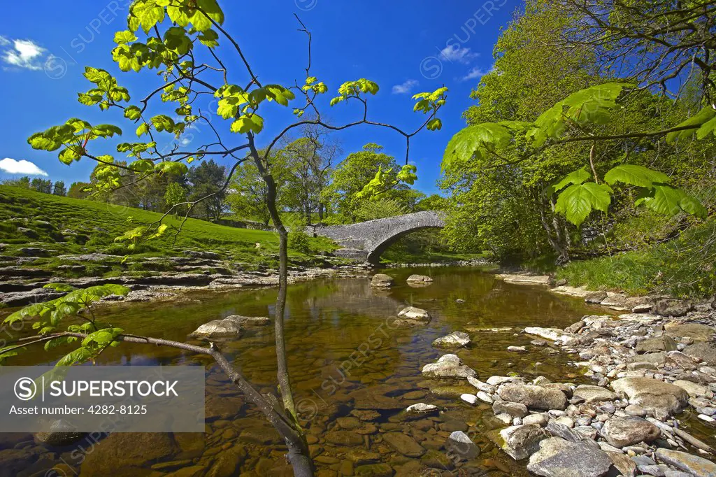 England, North Yorkshire, Stainforth. 17th Century packhorse bridge spanning the River Ribble.