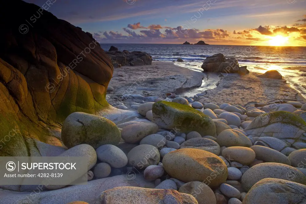 England, Cornwall, St Just. Sunset at Porth Nanven, known locally as Dinosaur Egg Beach due to the large number of ovoid rocks found there.