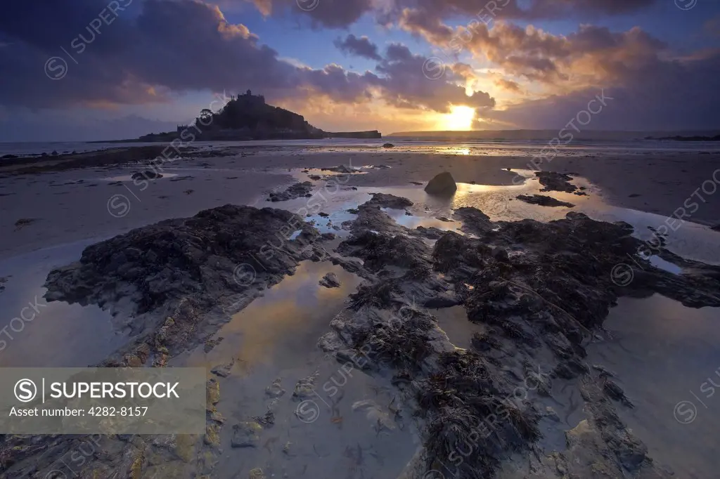 England, Cornwall, Marazion. Sunset over St Michaels Mount in Mount's Bay from the beach at Marazion.
