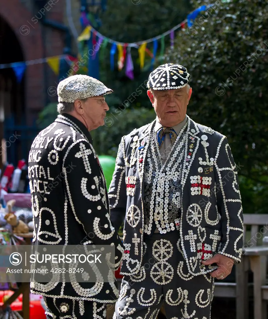 England, London, Covent Garden. The Pearly King of Highgate in conversation with the Pearly King of Crystal Palace.