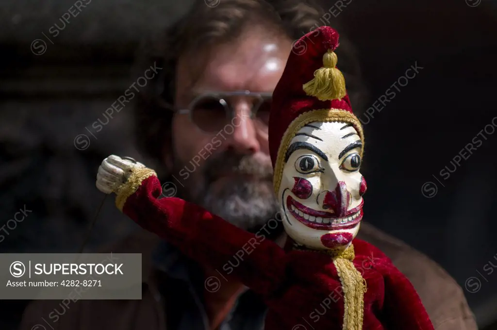 England, London, Covent Garden. Mr Punch and a puppeteer at the annual Punch and Judy festival held in Covent Garden.