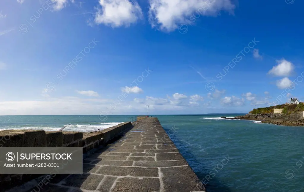 England, Cornwall, Porthleven. A panoramic view along the harbour wall out to sea at the entrance to Porthleven Harbour.