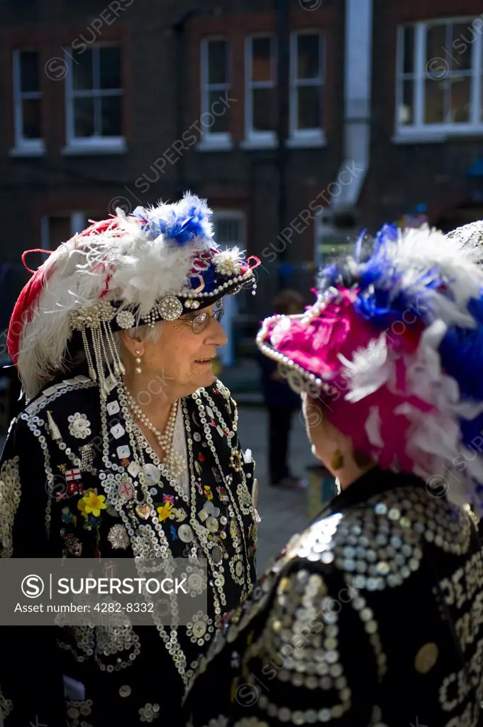 England, London, Covent Garden. Pearly Queens talking together in Covent Garden.