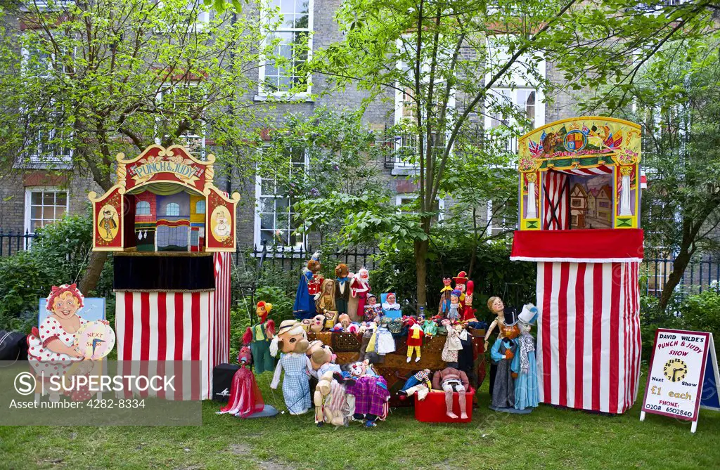 England, London, Covent Garden. Punch and Judy booths and puppets in the grounds of St Pauls Church at the annual Punch and Judy festival in Covent Garden.