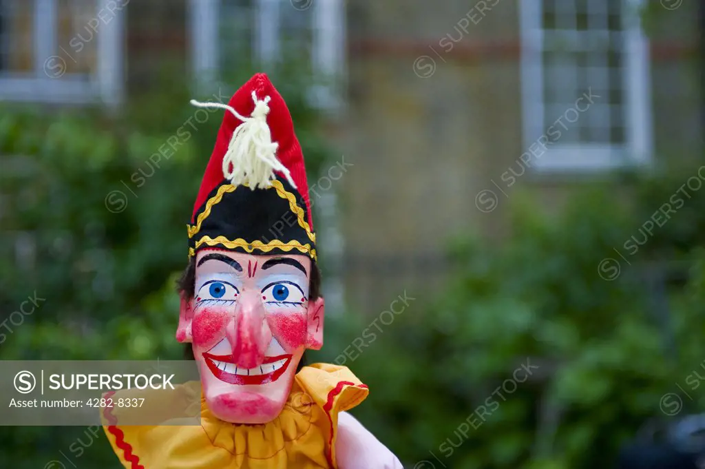 England, London, Covent Garden. Mr Punch puppet in a booth during a performance at the annual Punch and Judy festival in Covent Garden.