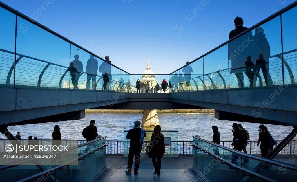 England, London, Bankside. People walking on the Millennium Bridge at Bankside looking towards St Paul's Cathedral on the north bank of the River Thames.