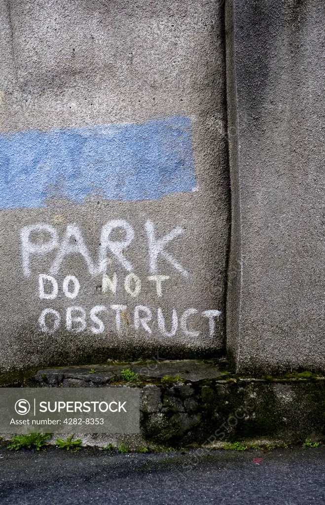 England, Cornwall, St Ives. 'Park' written on a wall contrary to the 'Do Not Obstruct' message below.