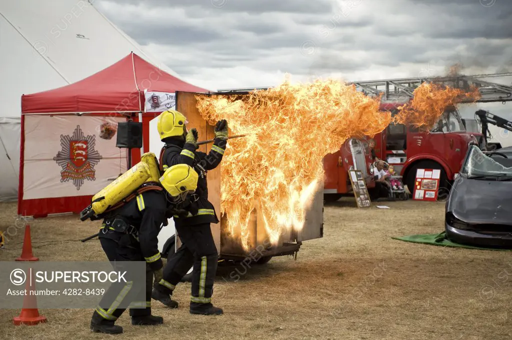 England, Essex, Orsett. Firemen from the Essex Fire Service demonstrating the dangers of a chip pan fire at the Orsett Show, one of the oldest one-day Country Shows in England.