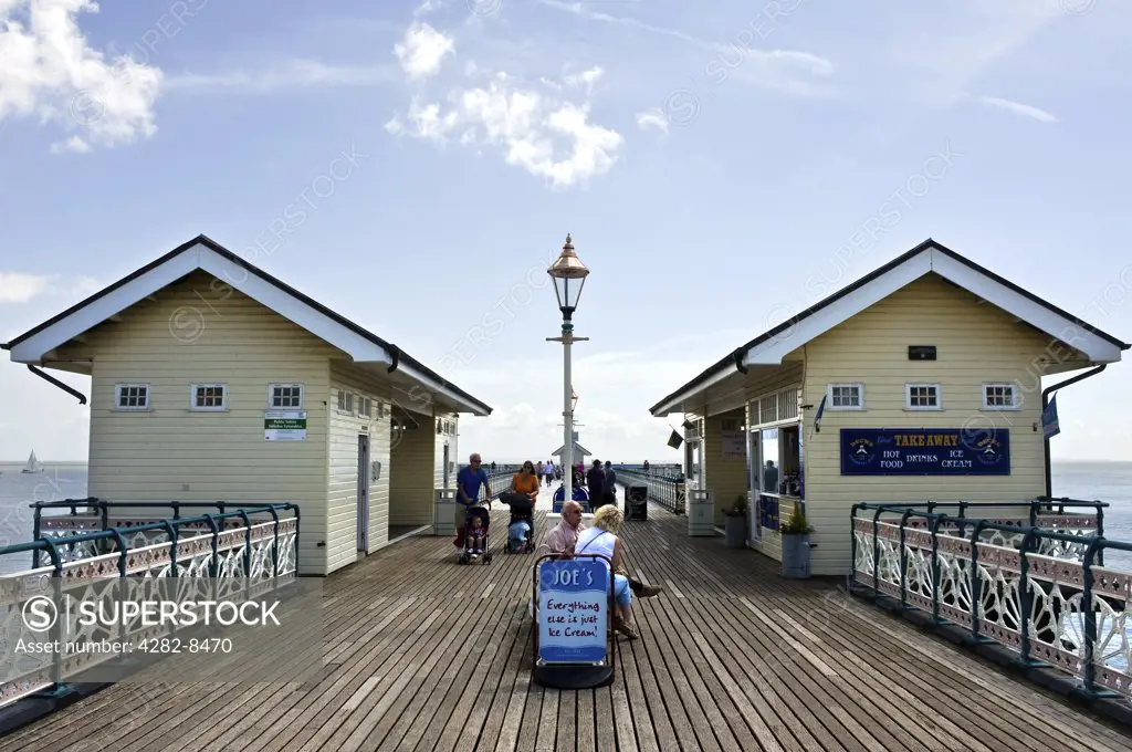 Wales, The Vale of Glamorgan, Penarth. People strolling along Penarth Pier, one of the last remaining Victorian piers in Wales on the north shore of the Severn Estuary.